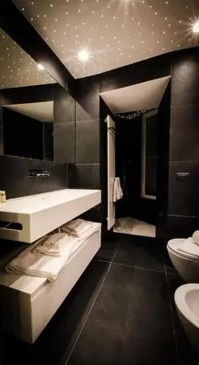 a black bathroom with a sink and a toilet at Domus Quiritum Elite, Vatican luxury apartment in Rome