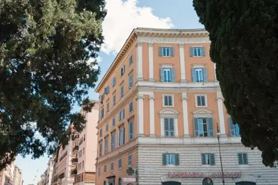 a large building with blue windows on a street at Domus Quiritum Elite, Vatican luxury apartment in Rome