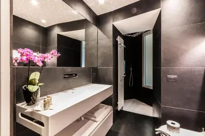 a bathroom with a white sink and a mirror at Domus Quiritum Elite, Vatican luxury apartment in Rome