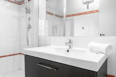 a white bathroom with a sink and a shower at Domus Quiritum Charming, Appartamento d'Epoca a Campo de' Fiori in Rome