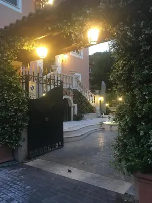 a gate to a house at night with lights at B&B VILLINO MARGHERITA in Rome