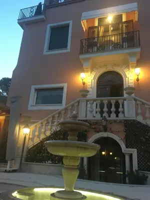 a yellow fountain in front of a building at B&B VILLINO MARGHERITA in Rome