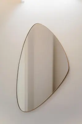 a mirror with a metal frame on a wall at L'Agata (Trastevere) in Rome