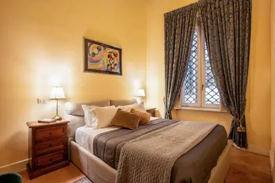 a bedroom with a bed and a window at Residenza Sinibaldi - XVII century experience in Rome