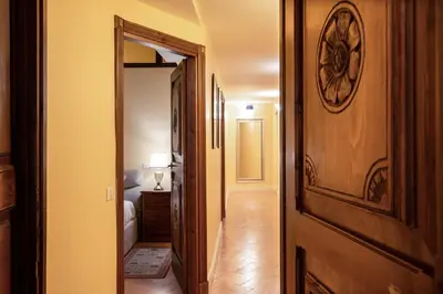 a hallway with a door leading to a bedroom at Residenza Sinibaldi - XVII century experience in Rome