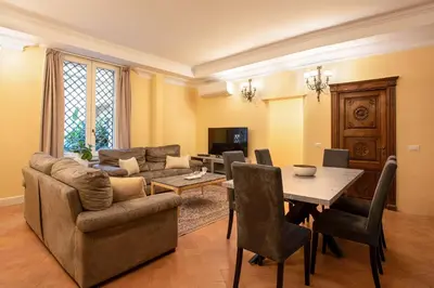 a living room with a couch and a table at Residenza Sinibaldi - XVII century experience in Rome