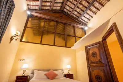 a bedroom with a bed and a wooden ceiling at Residenza Sinibaldi - XVII century experience in Rome