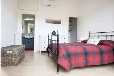 a bedroom with a bed and a bathroom with a sink at Suite GG in Vatican in Rome