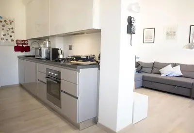 a kitchen with a stove top oven next to a couch at Suite GG in Vatican in Rome