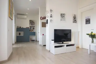 a living room with a flat screen tv on a white cabinet at Suite GG in Vatican in Rome