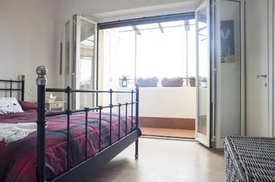 a bedroom with a bed and a sliding glass door at Suite GG in Vatican in Rome