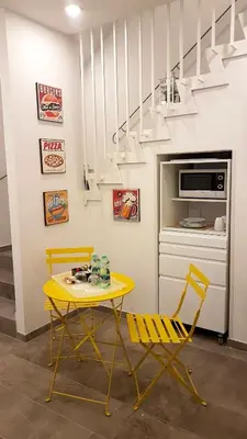 a yellow table and two yellow chairs in a room at CIVICO 7 Holiday Rooms in Rome