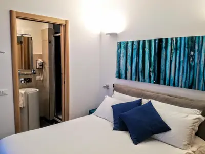 a bedroom with a bed with blue and white pillows at CIVICO 7 Holiday Rooms in Rome