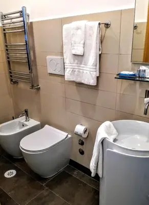 a bathroom with a white toilet and a sink at CIVICO 7 Holiday Rooms in Rome