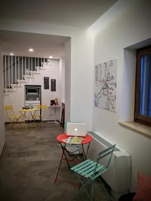 a room with a red table with a laptop on it at CIVICO 7 Holiday Rooms in Rome