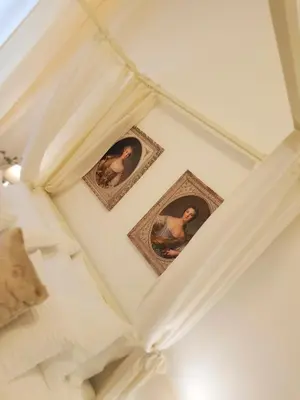 two pictures on the ceiling of a room at St Paul House Boutique & Apartment in Rome