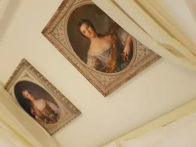 two framed portraits of a woman on a wall at St Paul House Boutique & Apartment in Rome