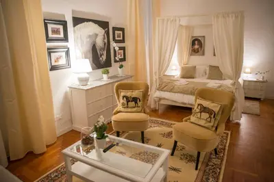 a bedroom with a bed and two chairs and a table at St Paul House Boutique & Apartment in Rome