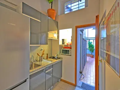 a kitchen with a sink and a microwave at Terrace Governo Vecchio in Rome