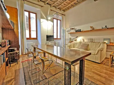 a living room with a table and a couch at Terrace Governo Vecchio in Rome