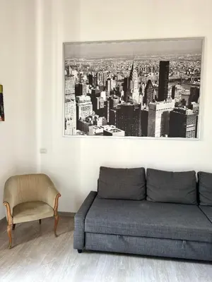 a living room with a couch and a chair at CasualSuiteMachiavelli in Rome