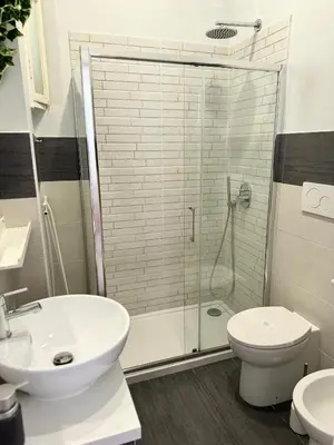 a bathroom with a shower and a toilet and a sink at CasualSuiteMachiavelli in Rome