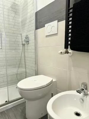 a bathroom with a toilet and a shower and a sink at CasualSuiteMachiavelli in Rome