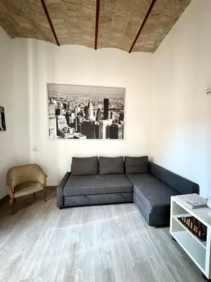 a living room with a couch and a table at CasualSuiteMachiavelli in Rome