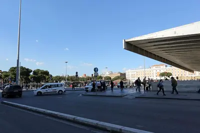 a group of people walking on a city street at Hotel Chicago in Rome