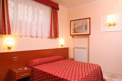 a bedroom with a red bed and a window at Hotel Chicago in Rome