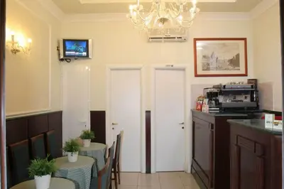 a kitchen with two tables and two white doors at Hotel Chicago in Rome