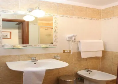 a bathroom with a sink and a mirror at Hotel Chicago in Rome