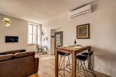 a living room with a table and a couch at Sant'eiligio loft campo di fiori in Rome