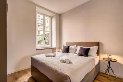 a bedroom with a large bed with two towels on it at Sant'eiligio loft campo di fiori in Rome