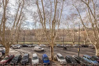 a parking lot with parked cars and trees at Sant'eiligio loft campo di fiori in Rome