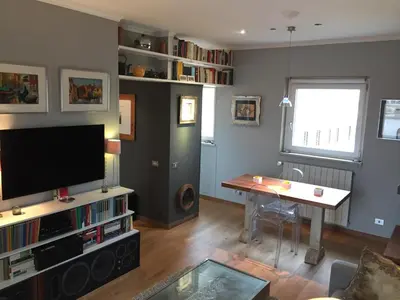 a living room with a flat screen tv and a table at Penthouseinrome in Rome