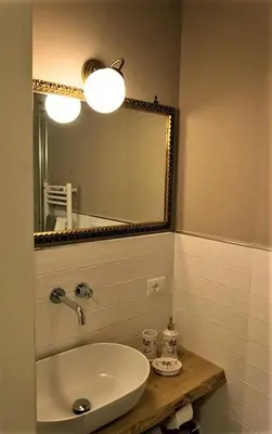 a bathroom with a sink and a mirror at St. Peter's Luxury Rooms in Rome