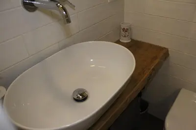 a white sink in a bathroom next to a toilet at St. Peter's Luxury Rooms in Rome