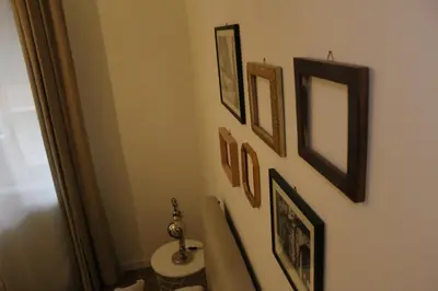 a bathroom with a toilet and pictures on the wall at St. Peter's Luxury Rooms in Rome