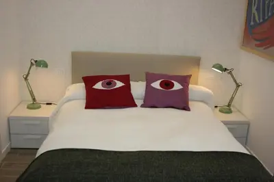 a bedroom with a bed with two eyes on it at Il B&B della Mamma in Rome