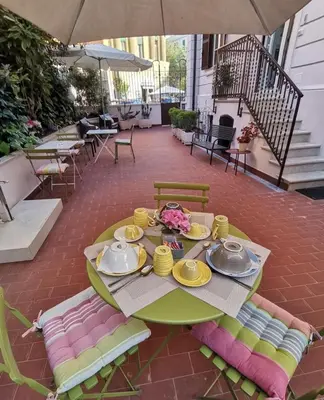 a table with plates and utensils on a patio at Il B&B della Mamma in Rome