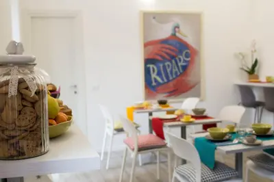 a dining room with a table with chairs and a bowl of fruit at Il B&B della Mamma in Rome