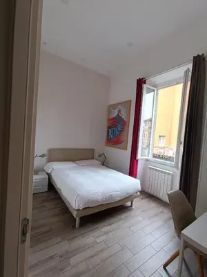 a bedroom with a white bed and a window at Il B&B della Mamma in Rome