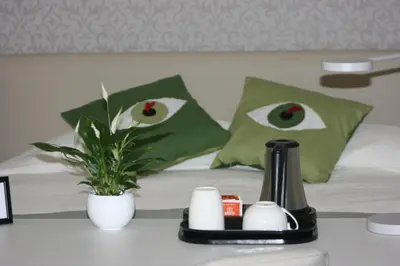a bed with green pillows with eyes on it at Il B&B della Mamma in Rome