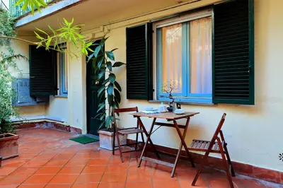 a table and chairs on a patio with windows at Characteristic apartment just beside the Vatican in Rome
