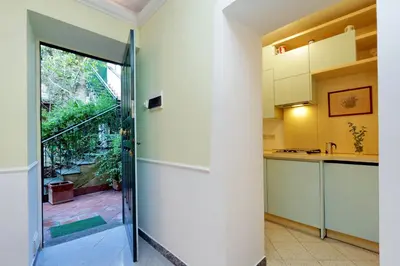a kitchen with a sliding glass door leading to a balcony at Characteristic apartment just beside the Vatican in Rome
