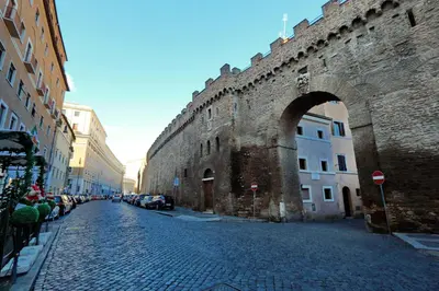an old brick street with an arch in a castle at Characteristic apartment just beside the Vatican in Rome