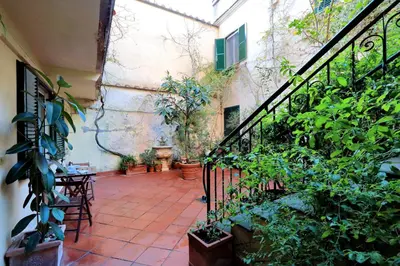 an outdoor patio with plants and a staircase at Characteristic apartment just beside the Vatican in Rome