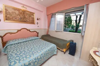 a bedroom with a bed and a window at B&B Babri Simim Taj in Rome