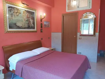 a red bedroom with a bed with a purple blanket at B&B Babri Simim Taj in Rome